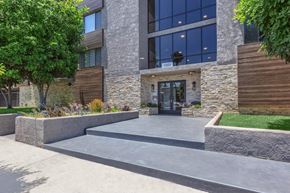 Los Angeles apartment for rent - A modern building with a stone facade and a glass entrance at Lafayette Apartments, California