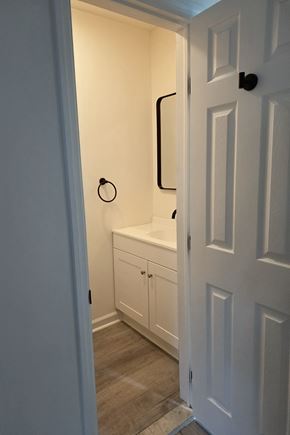 Dover townhouse for rent - A white door is open to a small bathroom.