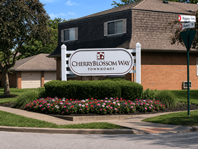 Reynoldsburg townhouse for rent - A sign for Cherryblossom Way townhomes stands in front of a brick building.