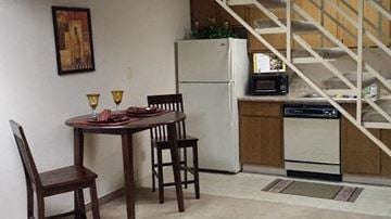 Reynoldsburg townhouse for rent - A kitchen with a table and chairs and a refrigerator.