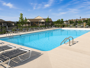 Findlay apartment for rent - A large swimming pool surrounded by lounge chairs.