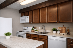 Hilliard townhouse for rent - A kitchen with brown cabinets and a white fridge.