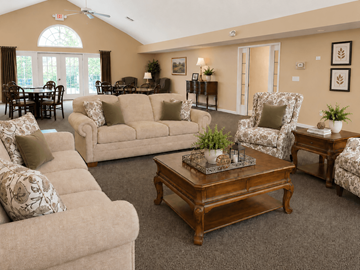 Zanesville apartment for rent - A living room with a variety of furniture including a couch, armchair, and coffee table.