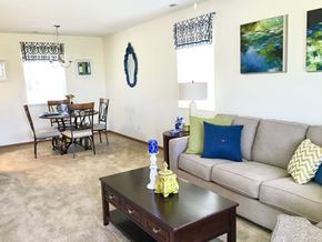 Huber Heights apartment for rent - A living room with a couch, coffee table, and dining table.