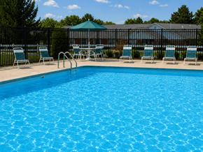 Springfield apartment for rent - A pool with blue water and chairs around it.