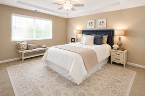 Springfield apartment for rent - A bedroom with a large bed and a window with blinds.