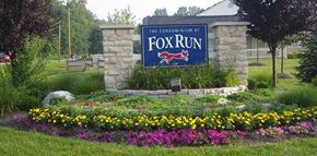 Newark apartment for rent - A sign that says "The Condominium at Fox Run" is surrounded by flowers.