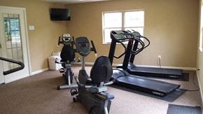 Heath apartment for rent - A home gym with a treadmill, elliptical trainer and a stationary bike.