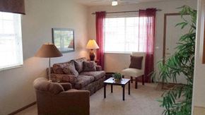 Heath apartment for rent - A living room with a couch, chair, and lamp.