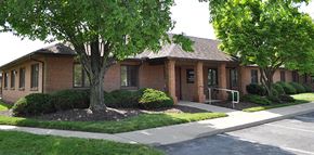Springfield apartment for rent - a small brick building with a tree in front of it