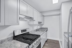 Washington apartment for rent - A modern kitchen with a granite countertop and stainless steel appliances.
