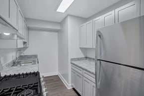 Washington apartment for rent - A kitchen with a stove top oven and a refrigerator.