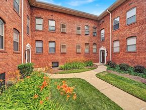 Washington apartment for rent - A red brick building with a white door and windows.