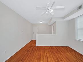 Washington apartment for rent - A room with a ceiling fan and wooden flooring.