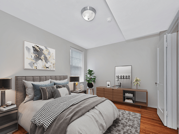 Washington apartment for rent - A bedroom with a large bed and a mirror on the wall.