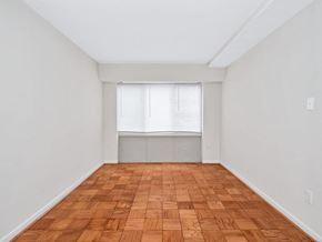 Washington apartment for rent - A room with wooden flooring and a window with blinds.