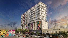 Miami apartment for rent - A modern building with a mural on the side is depicted in the image.