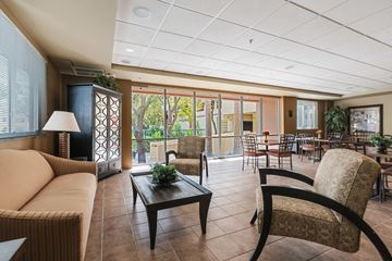 Miami apartment for rent - a living room with a couch and chairs and a table