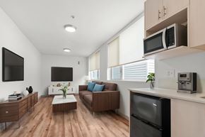 Seattle apartment for rent - A modern kitchen with a refrigerator, microwave, and oven.