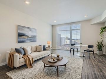 Seattle apartment for rent - A living room with a couch, a coffee table, and a painting on the wall.