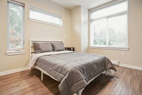 Seattle apartment for rent - A bedroom with a large bed and two windows.