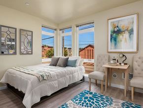 Seattle apartment for rent - a bedroom with a bed and a desk and windows