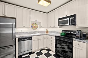Seattle apartment for rent - a kitchen with stainless steel appliances and checkered floors