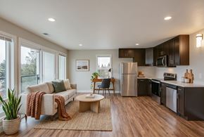 Seattle apartment for rent - A modern kitchen with a refrigerator, microwave, and oven.