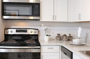 Silverdale apartment for rent - a kitchen with white cabinets and stainless steel appliances