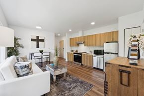 Seattle apartment for rent - A modern kitchen with wooden cabinets and a white fridge.