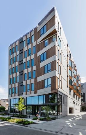 Seattle apartment for rent - a tall building with a street in front of it