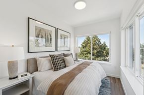 Seattle apartment for rent - A bedroom with a large bed and two framed pictures on the wall.