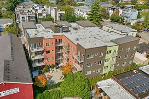 Seattle apartment for rent - Aerial view of REV Fremont showing colorful modern exterior, balconies, and central courtyard patio.