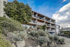 Seattle apartment for rent - Exterior view of the building with landscaping and architectural details.