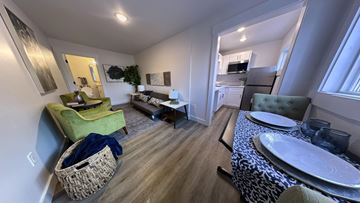Seattle apartment for rent - a living room and dining room with a table and chairs