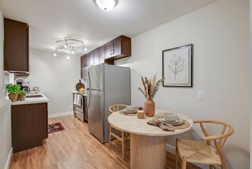 Seattle apartment for rent - A kitchen with a table and chairs in the middle of the room.
