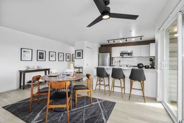Seattle apartment for rent - a living area with a dining table and chairs and a kitchen with a counter