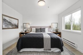 Seattle apartment for rent - a bedroom with a large bed and two windows