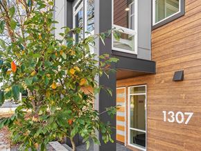 Seattle apartment for rent - a tree is growing in front of a building