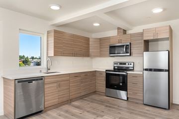 Seattle apartment for rent - A modern kitchen with wooden cabinets and stainless steel appliances.