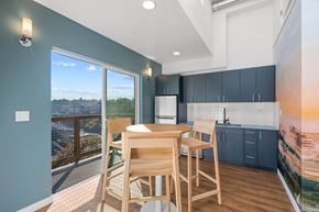 Seattle apartment for rent - a dining room with a table and chairs and a balcony
