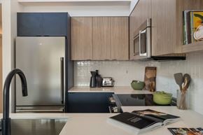 Seattle apartment for rent - a kitchen with wooden cabinets and stainless steel appliances