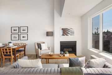 Seattle apartment for rent - a living room with a couch and a table and a fireplace