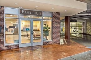 Seattle apartment for rent - A Hawthorne storefront with a glass door and a brick wall.