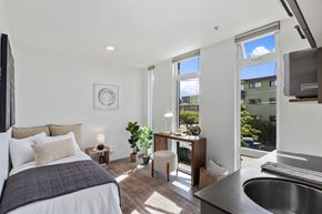 Seattle apartment for rent - a bedroom with a bed and a large window