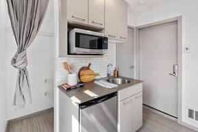 Seattle apartment for rent - a small kitchen with stainless steel appliances and a microwave