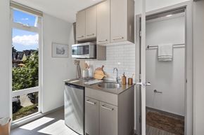 Seattle apartment for rent - a small kitchen with stainless steel appliances and a window