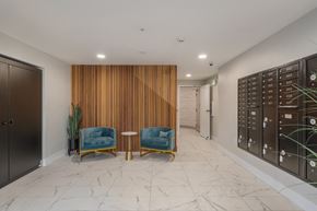 Seattle apartment for rent - A hallway with two chairs and a wooden wall panel.