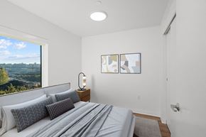 Seattle apartment for rent - a bedroom with a bed and a large window