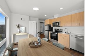 Seattle apartment for rent - an open kitchen and dining room with a wooden table